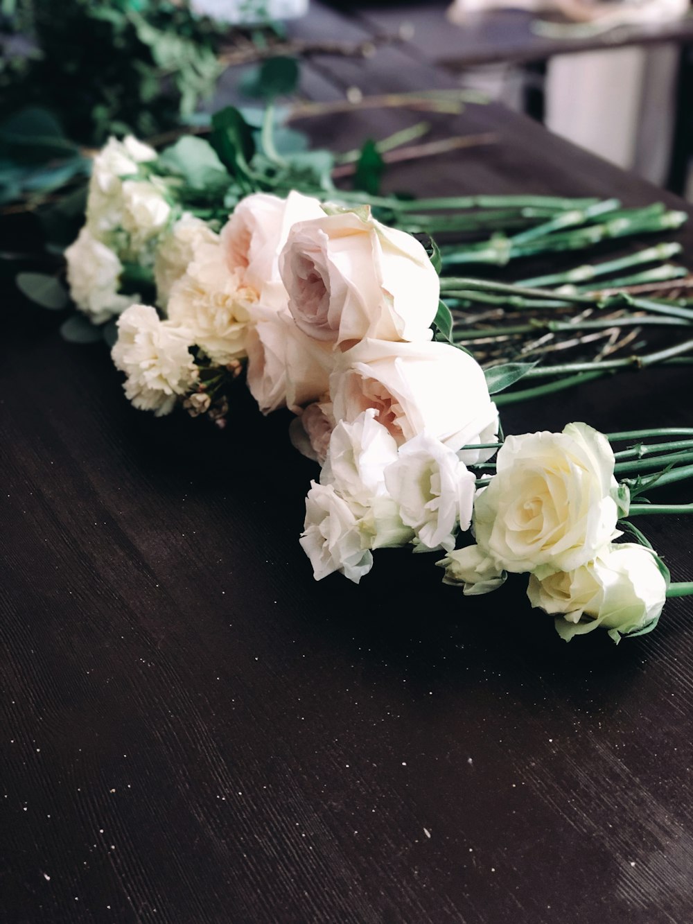 white flowers on brown wooden table