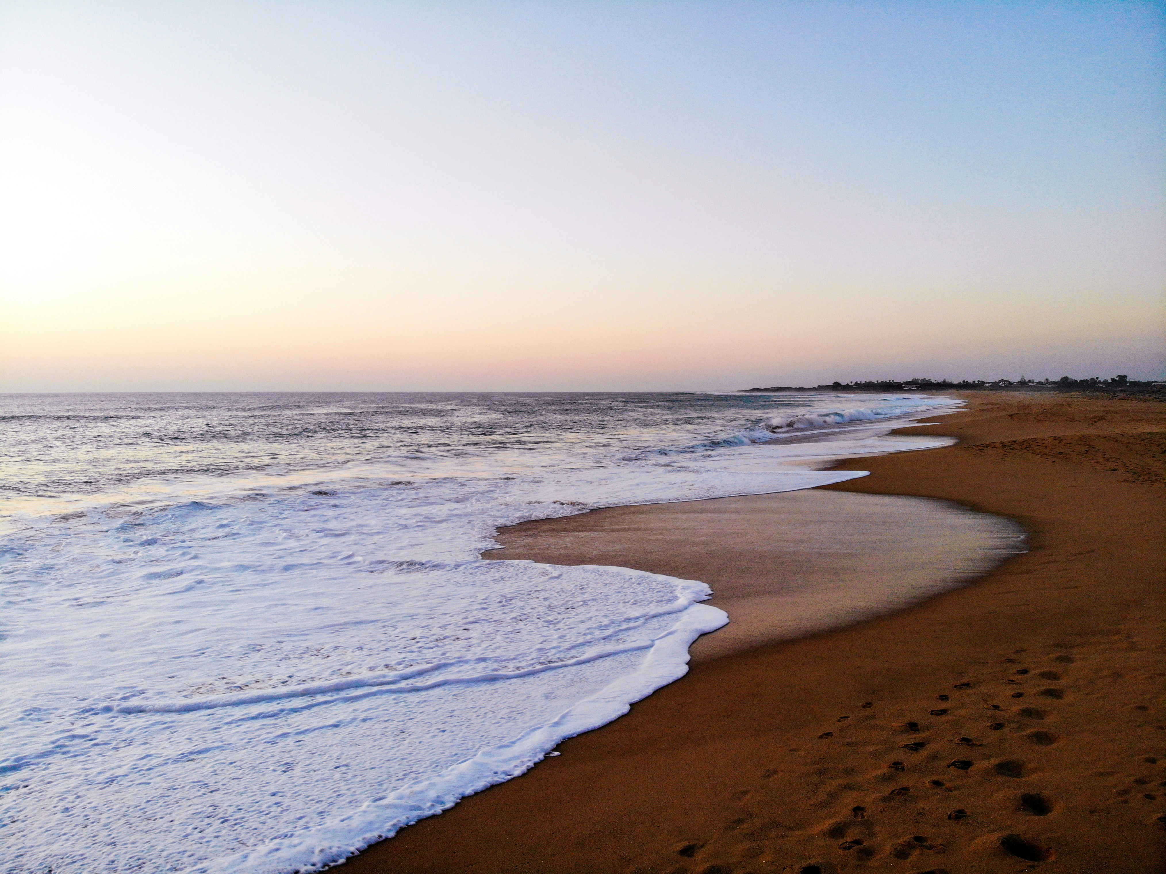 ocean waves crashing on shore during daytime