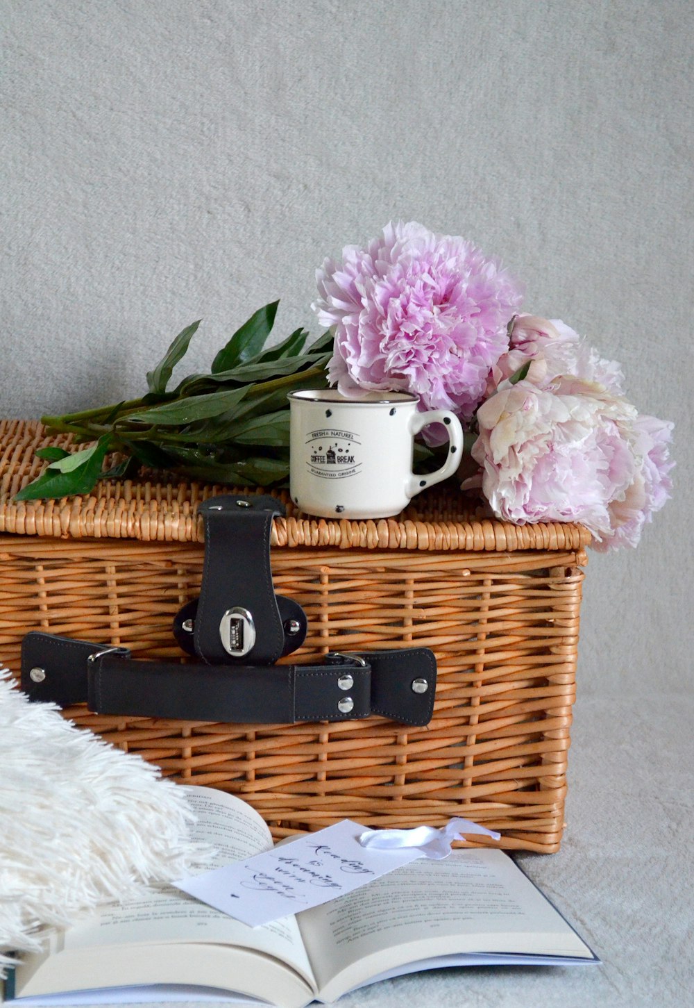 pink flowers on brown woven basket