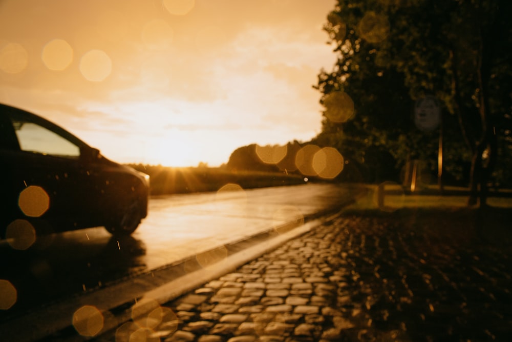 silhouette of person sitting on the road during sunset