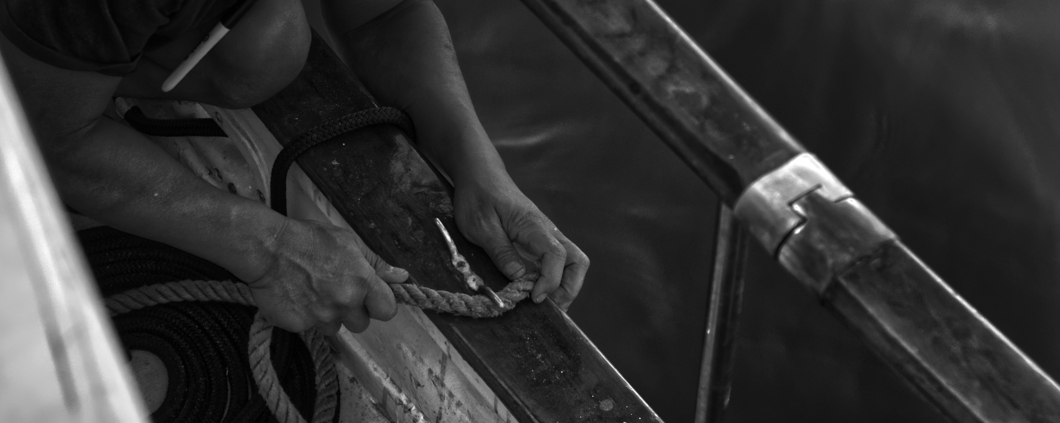 grayscale photo of person holding rope