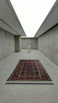 A serene Swiss interior featuring a minimalist room adorned with a vintage Afghan rug.