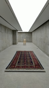 Elegant minimalist room featuring a light-toned Moroccan carpet adding warmth and texture.