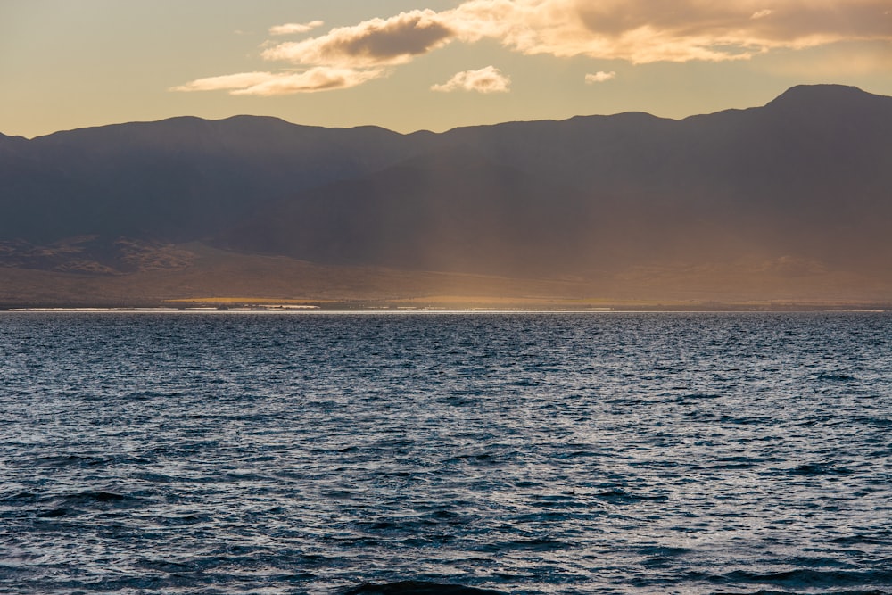 body of water under cloudy sky during daytime