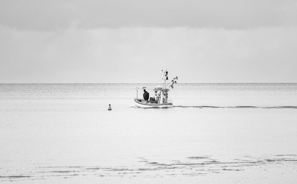 grayscale photo of 2 person riding on boat on sea