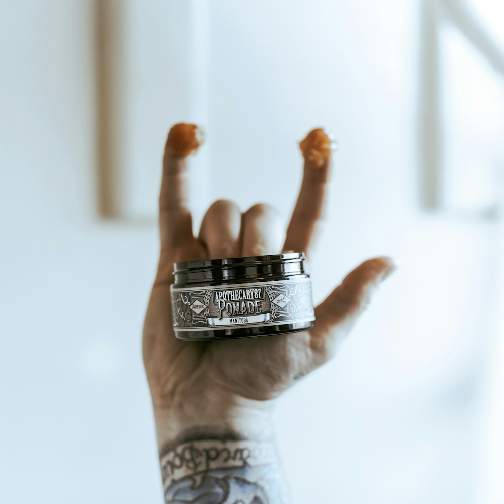 person wearing silver ring with black and silver ring