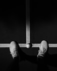 person wearing black and white sneakers
