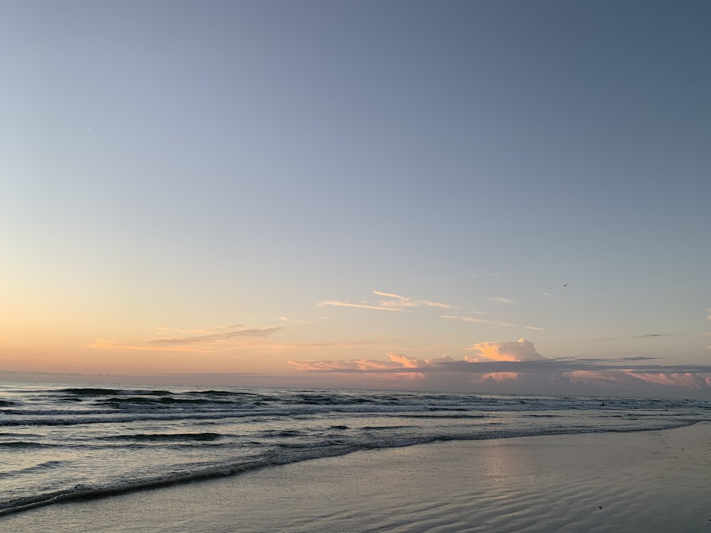 body of water during sunset