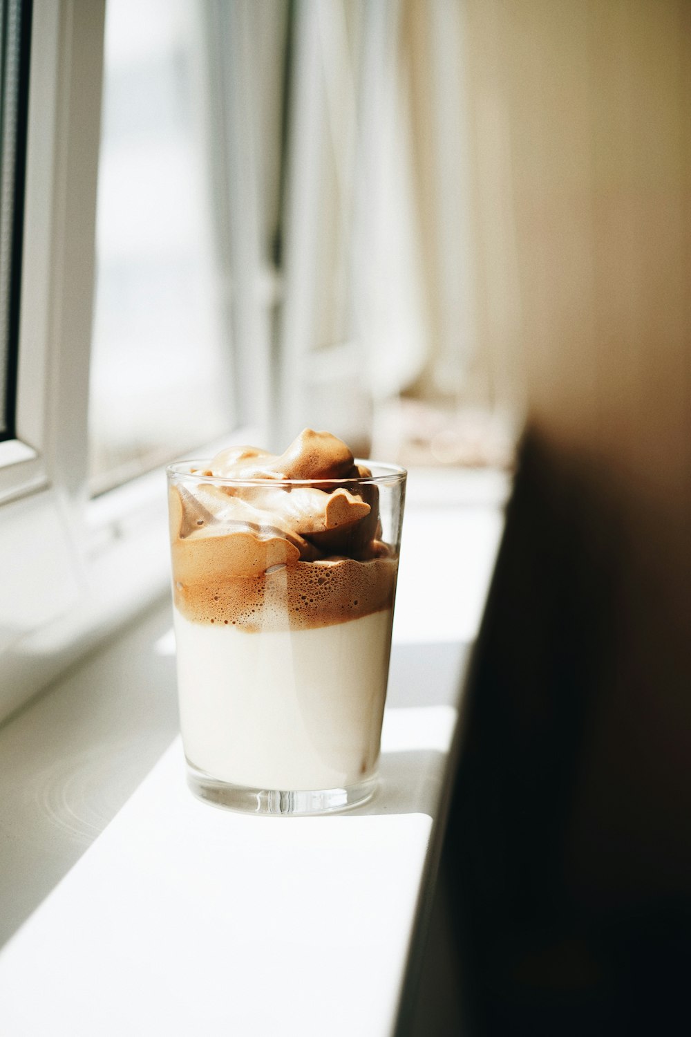 clear drinking glass with brown liquid