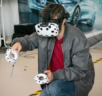 man in black jacket and blue denim jeans with white and black panda mask