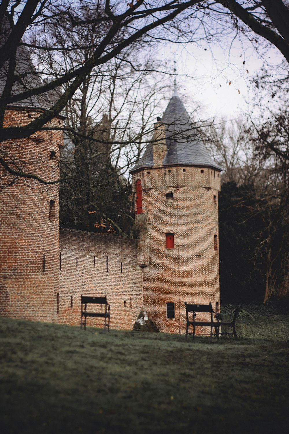 brown brick building near bare trees during daytime