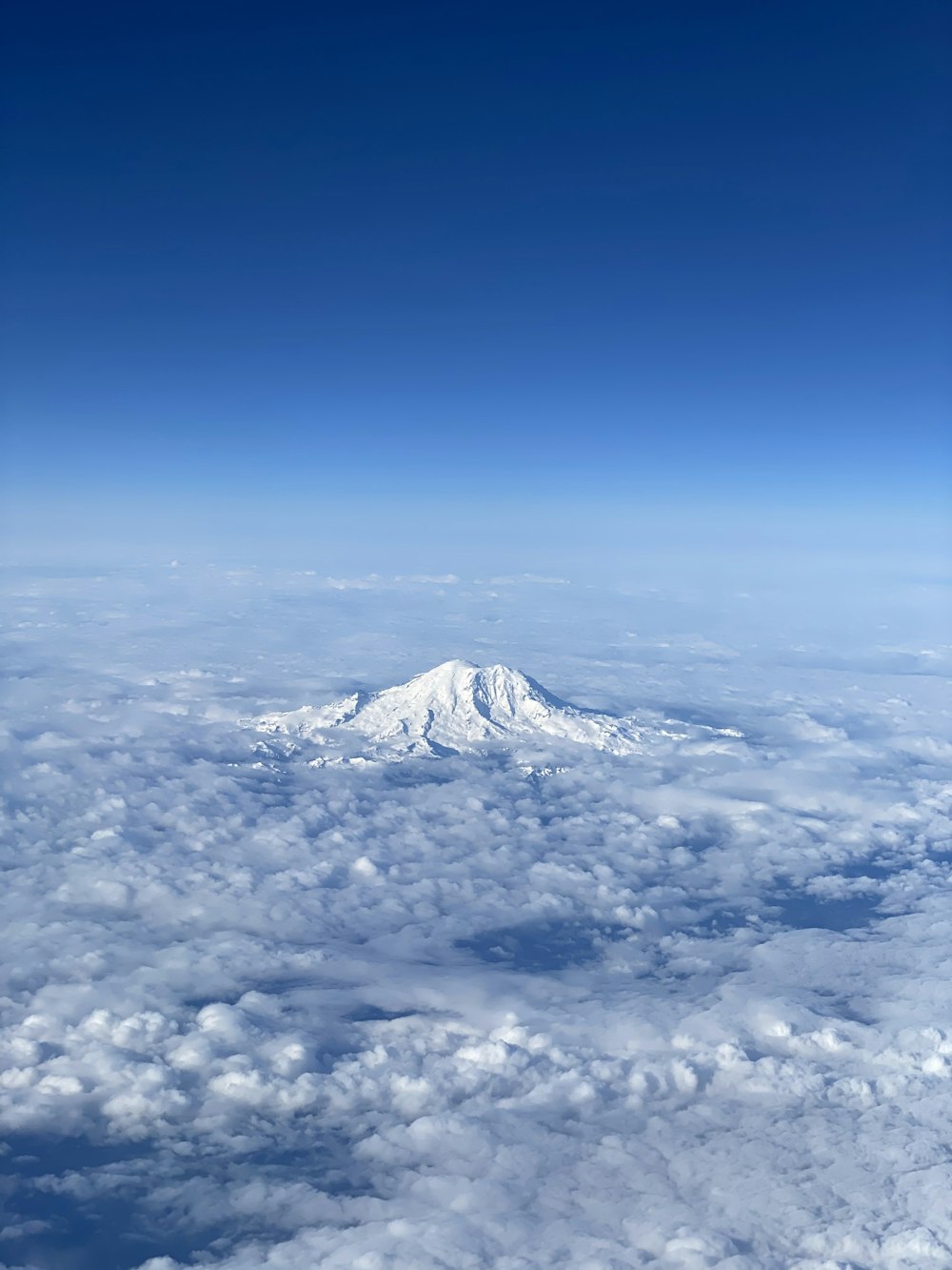 white clouds over snow covered mountain