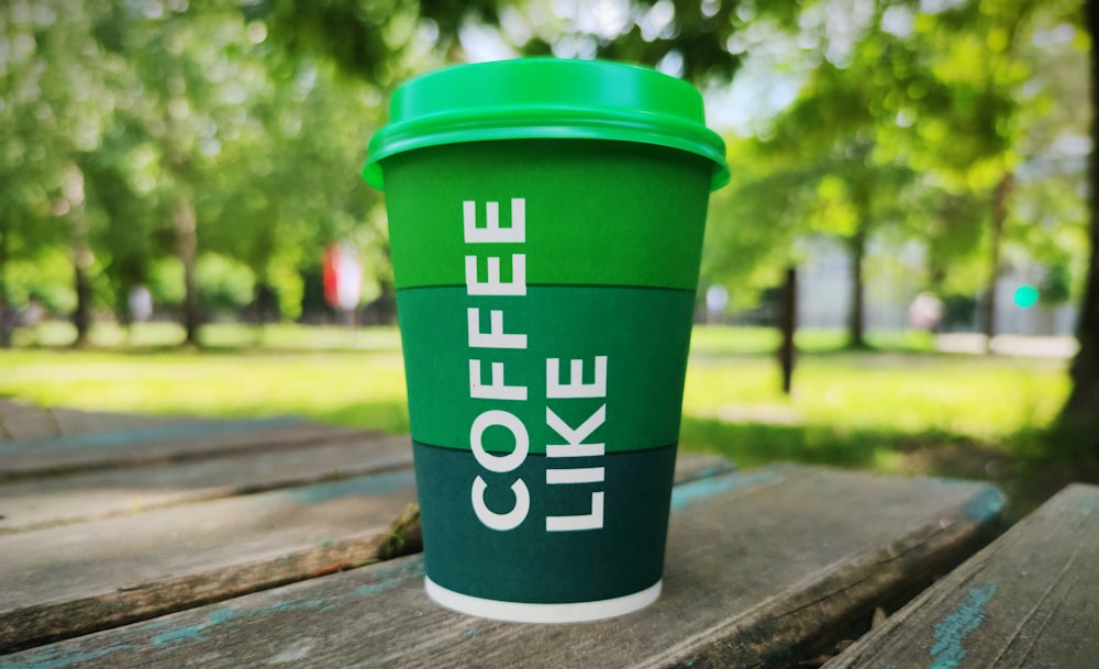 green and white plastic cup