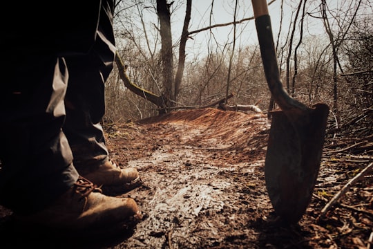 person in brown pants and brown boots holding brown wooden stick in Kentville Canada