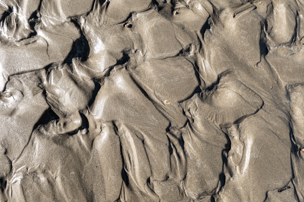 brown sand with footprints during daytime