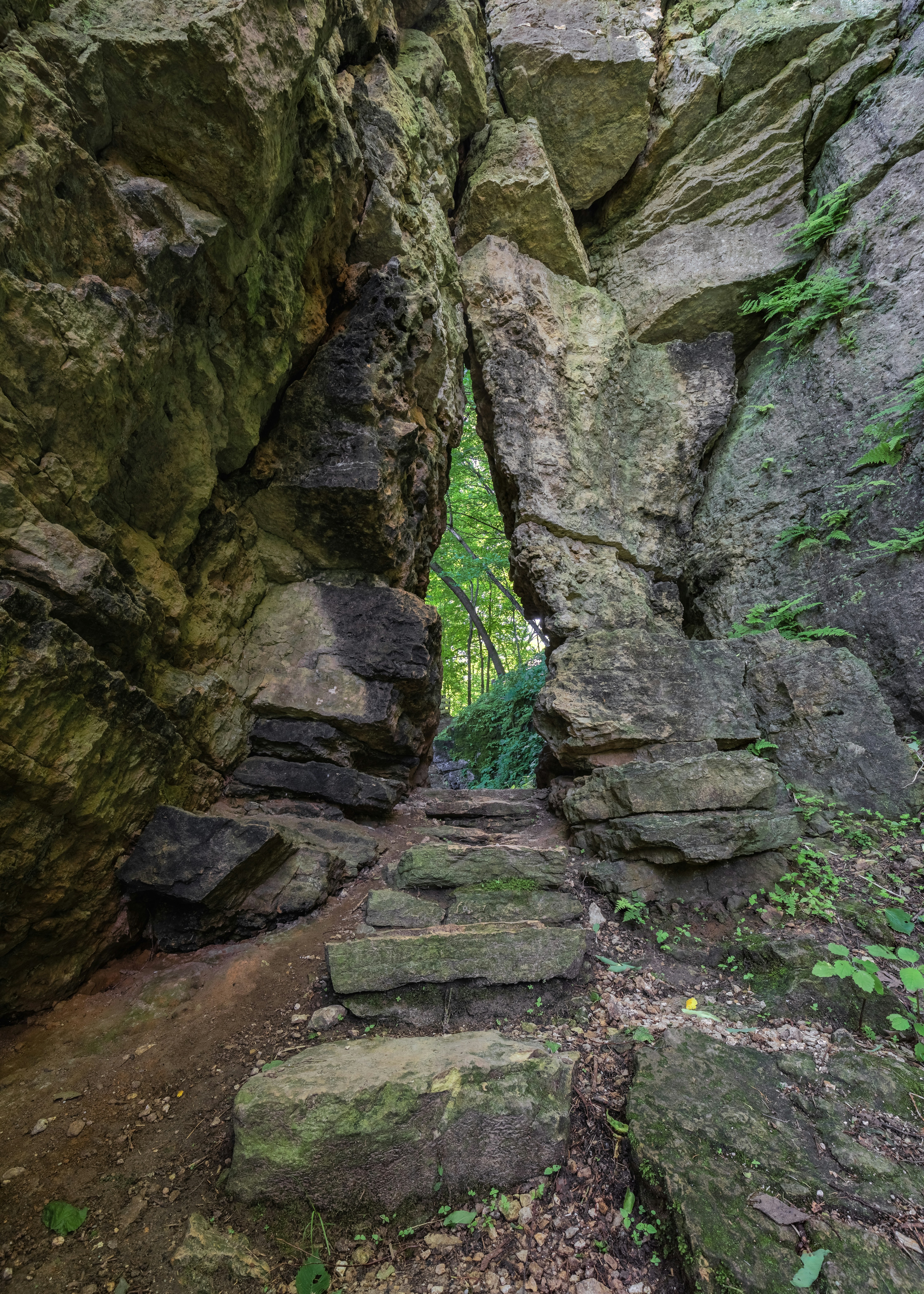 brown concrete stairs between brown rocky mountain during daytime