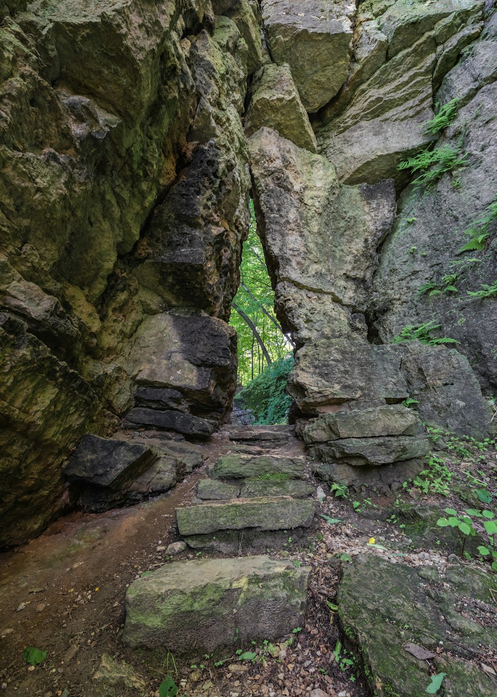 brown concrete stairs between brown rocky mountain during daytime