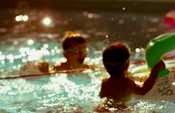 2 boys in swimming pool during daytime