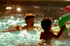 2 boys in swimming pool during daytime