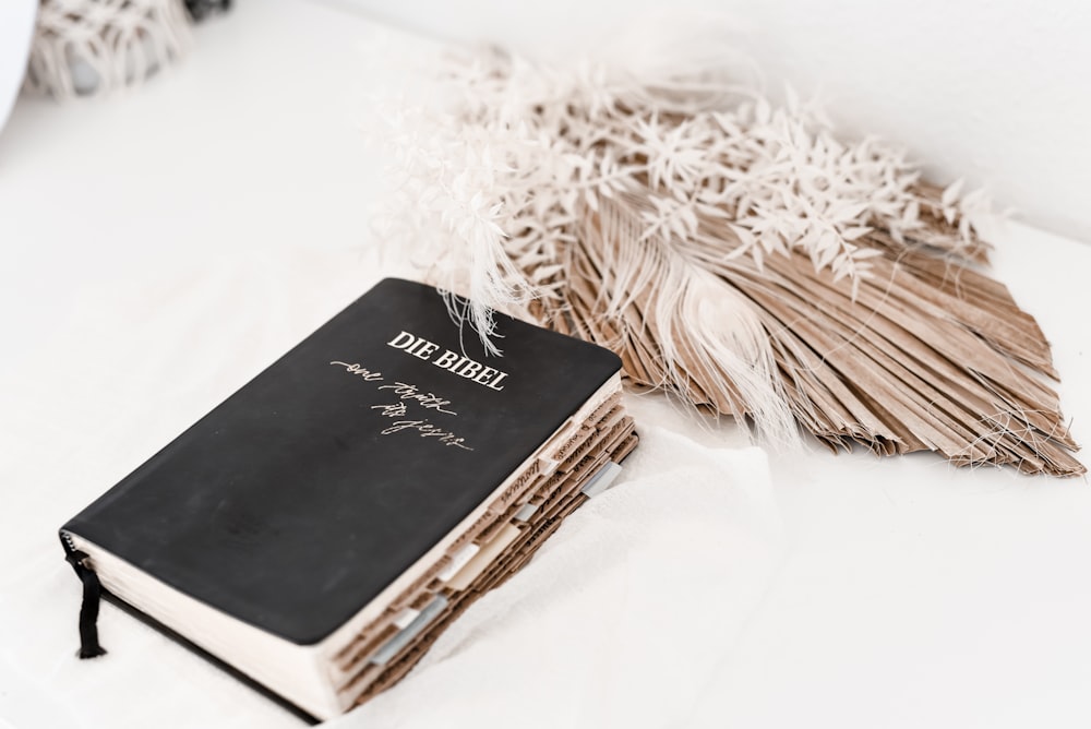 black book on white textile