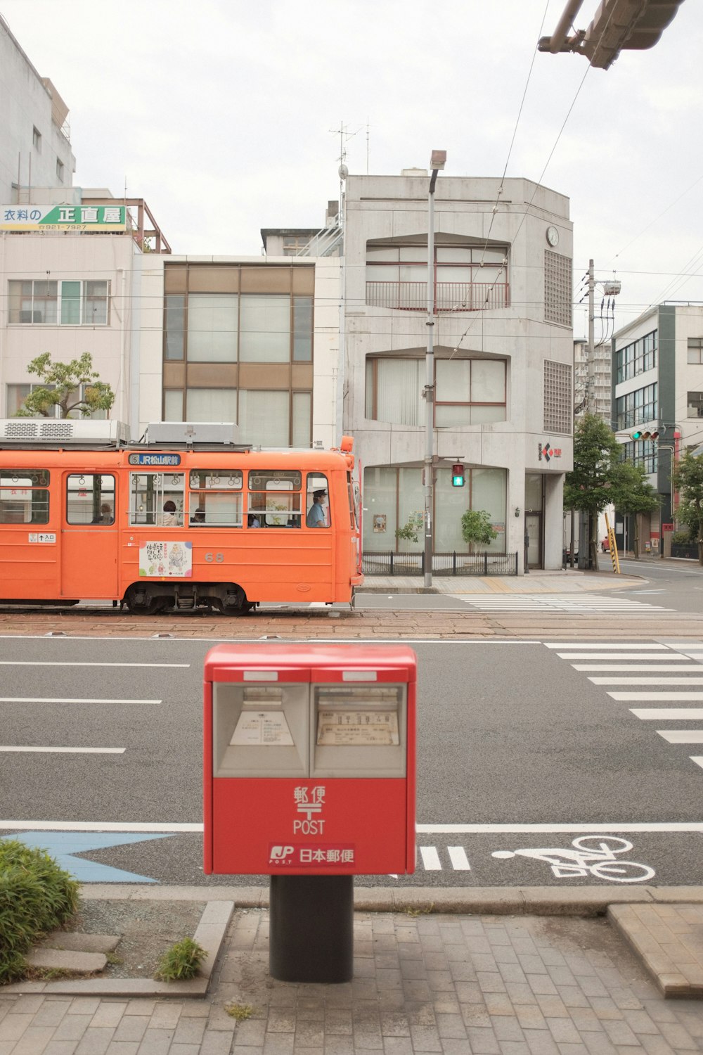 red double decker bus on road near building during daytime