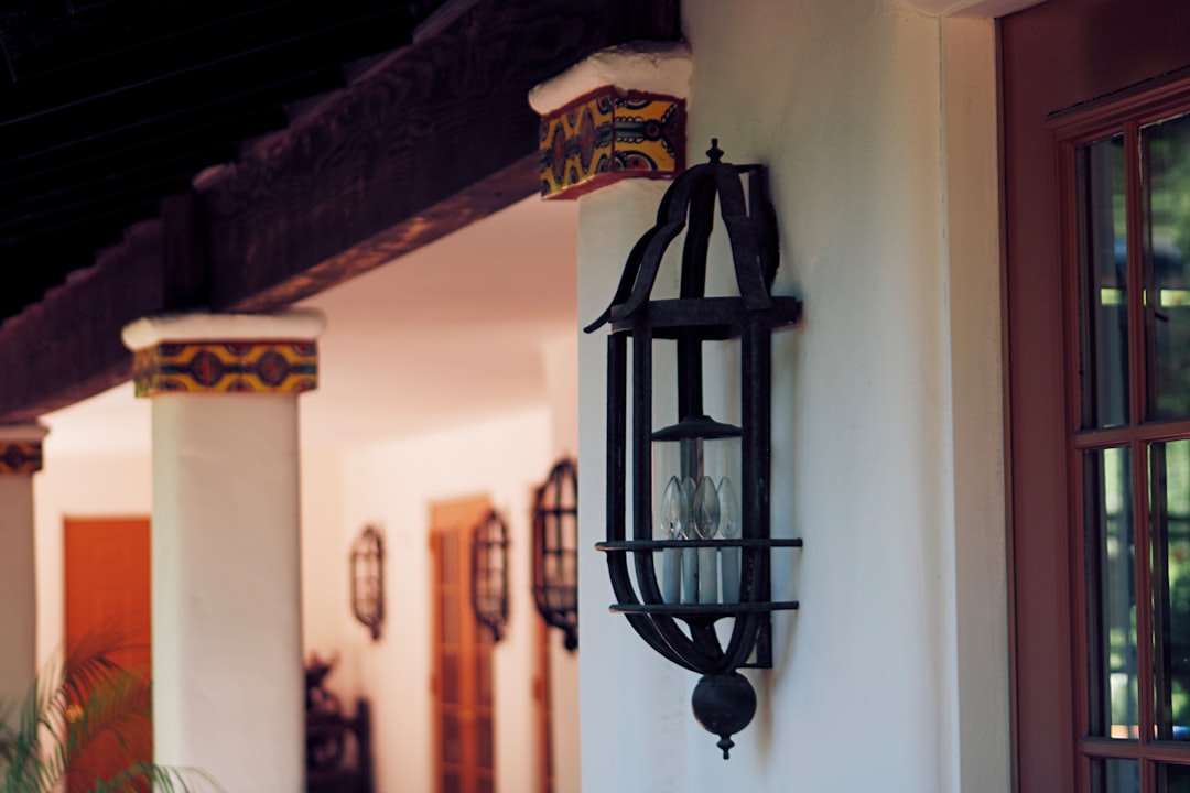 black metal candle lantern on white wall