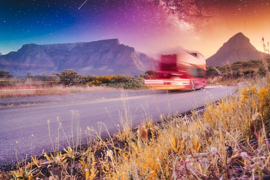 red car on road during night time in Table Mountain South Africa