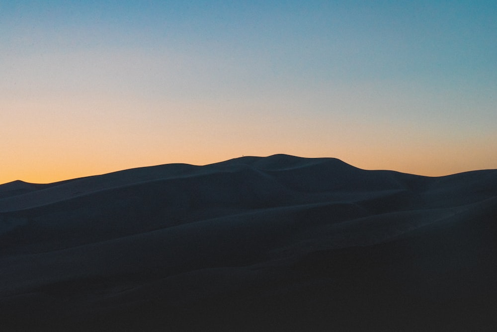 silhouette of mountain during sunset