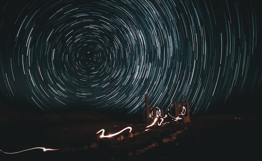 time lapse photography of man and woman sitting on sand