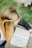 woman in black sweater reading book
