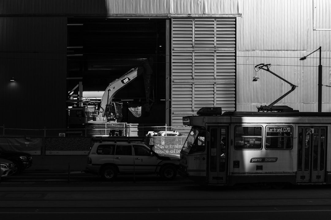 grayscale photo of cars in parking lot