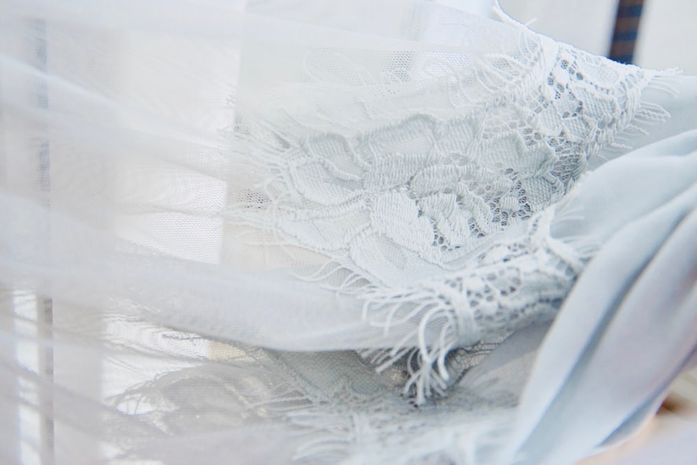 white floral textile on brown wooden table