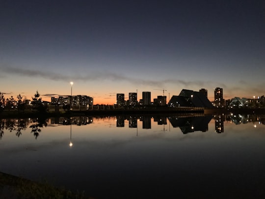 silhouette of building near body of water during night time in Astana Kazakhstan