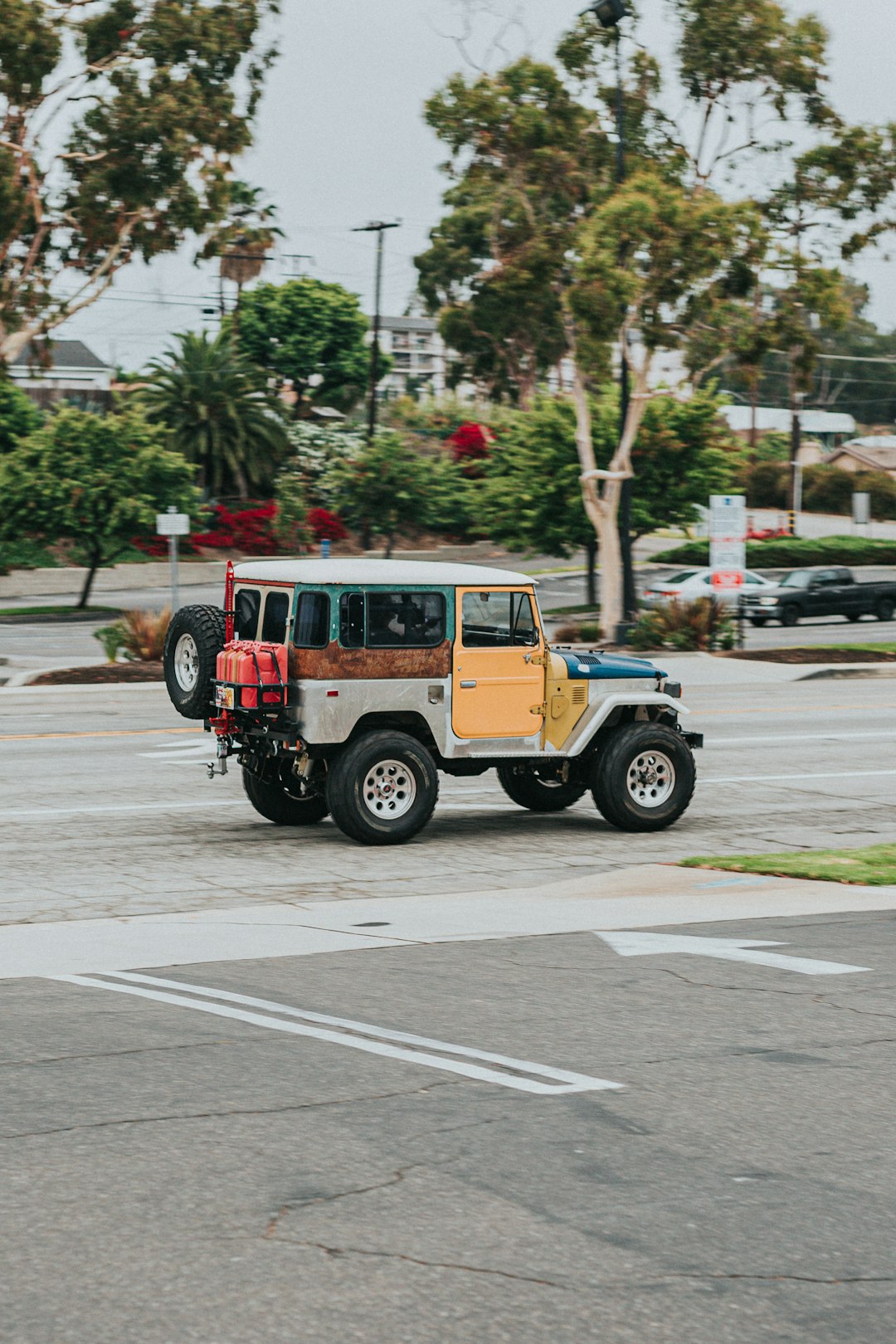 red and black jeep wrangler on road during daytime