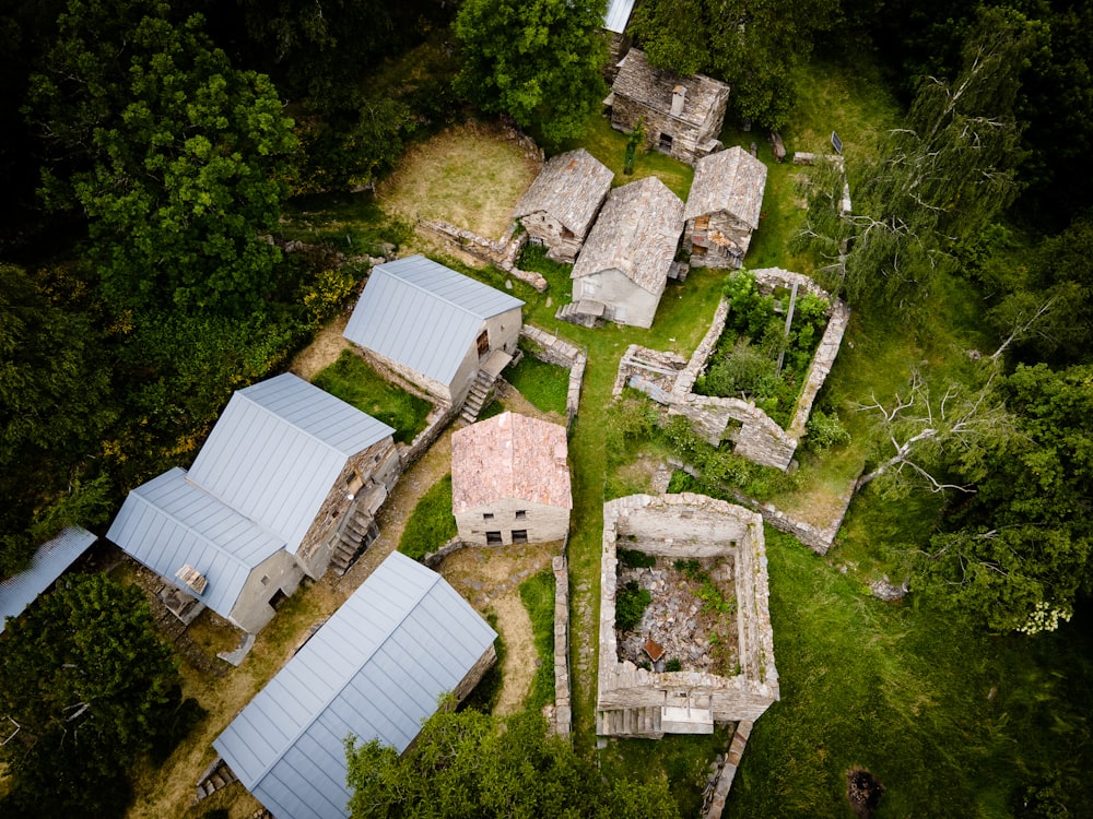 an aerial view of an abandoned village in the woods