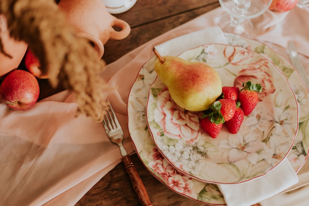 sliced apple on white and red floral ceramic plate