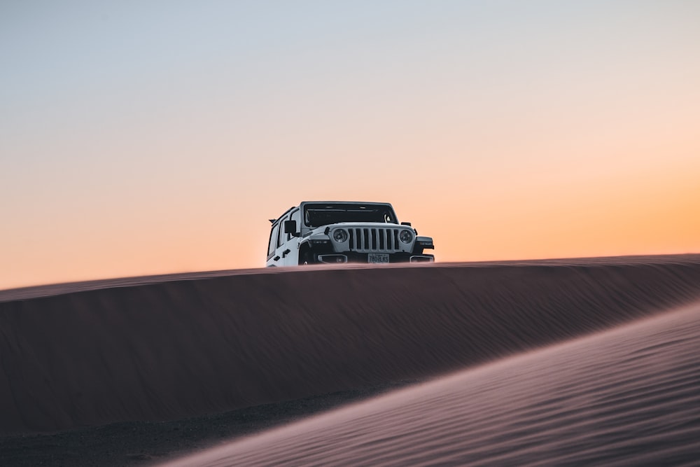 black and white truck on desert during daytime