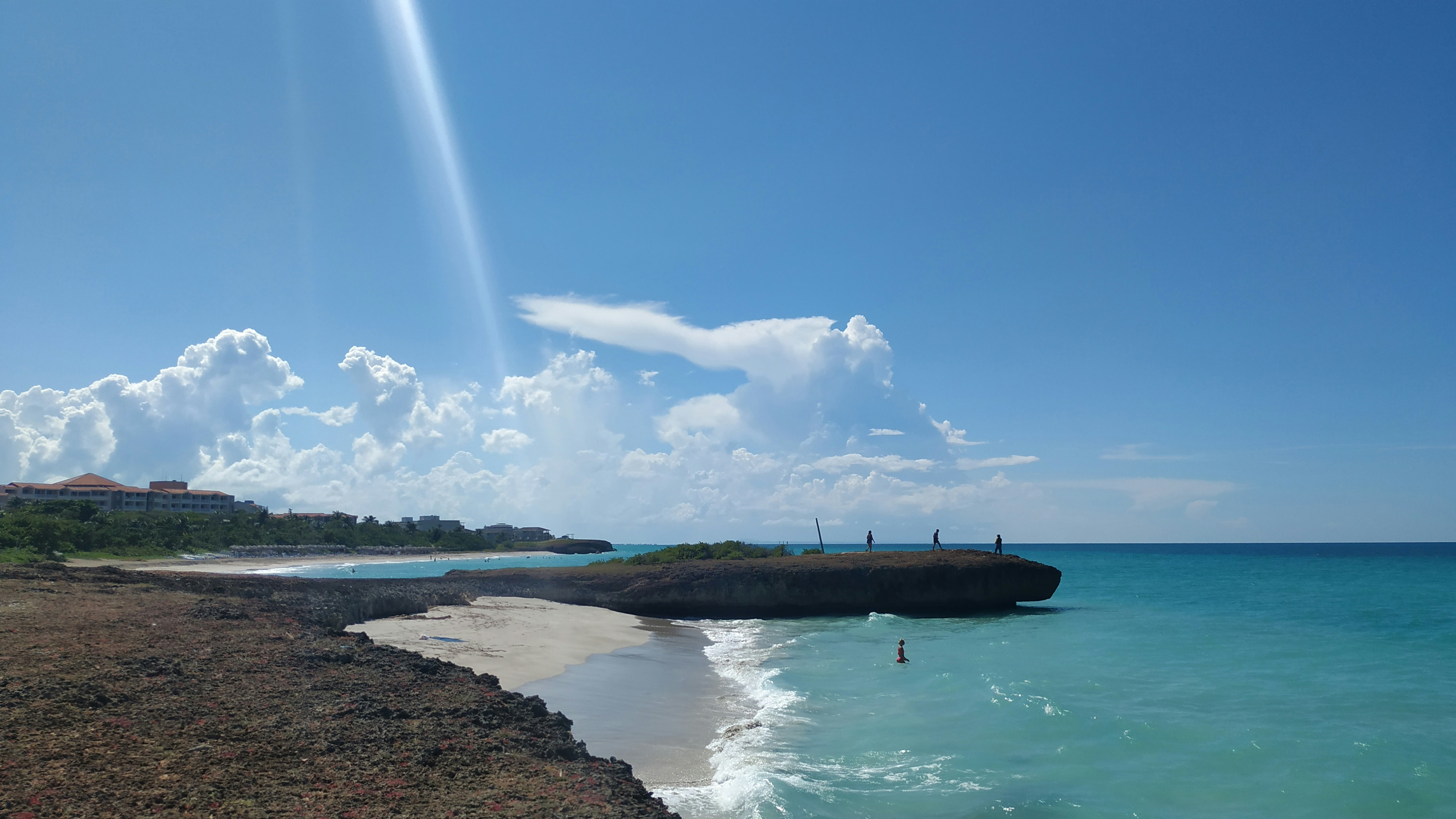brown wooden dock on sea under blue sky during daytime