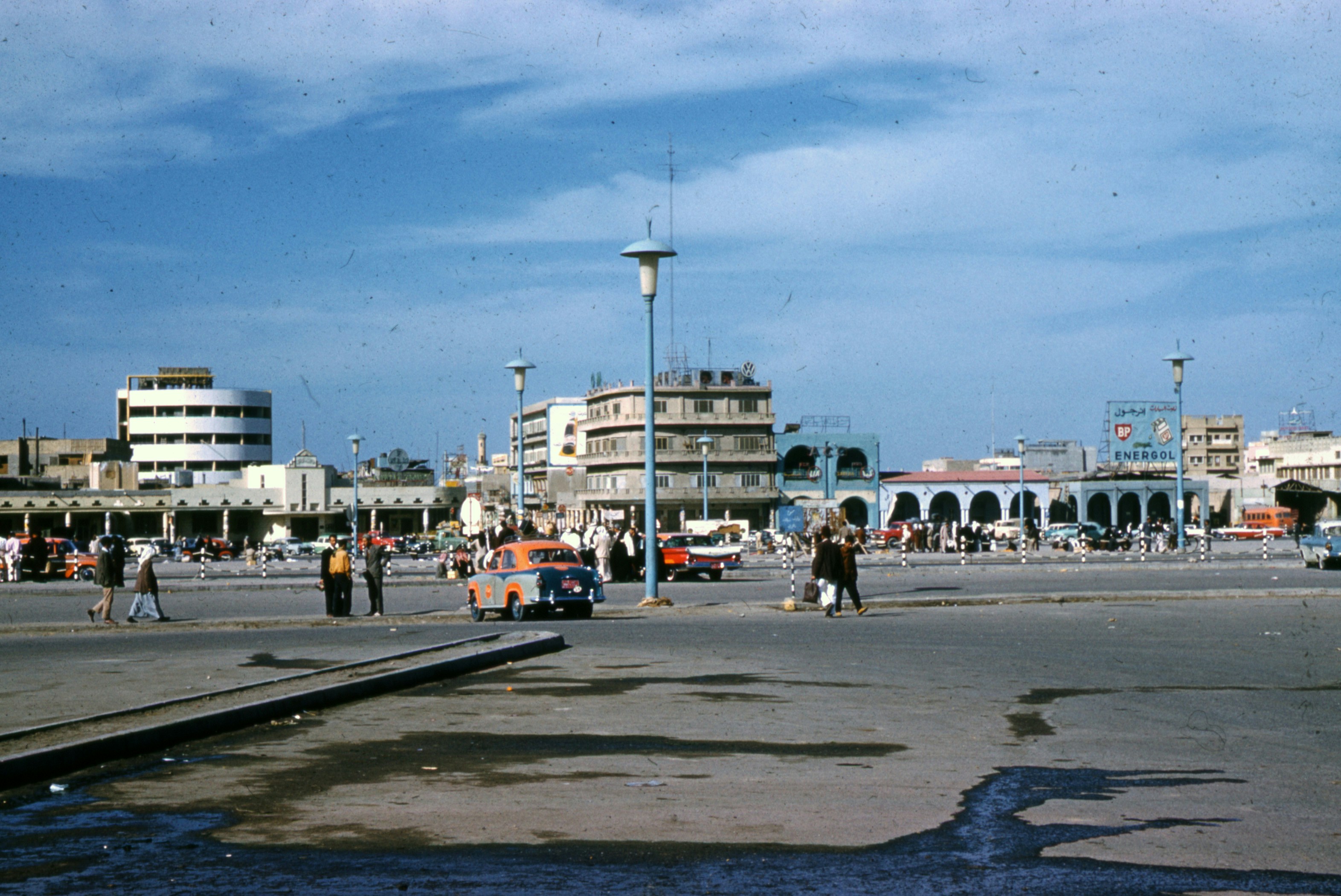 people walking on street near white and orange bus during daytime, 
