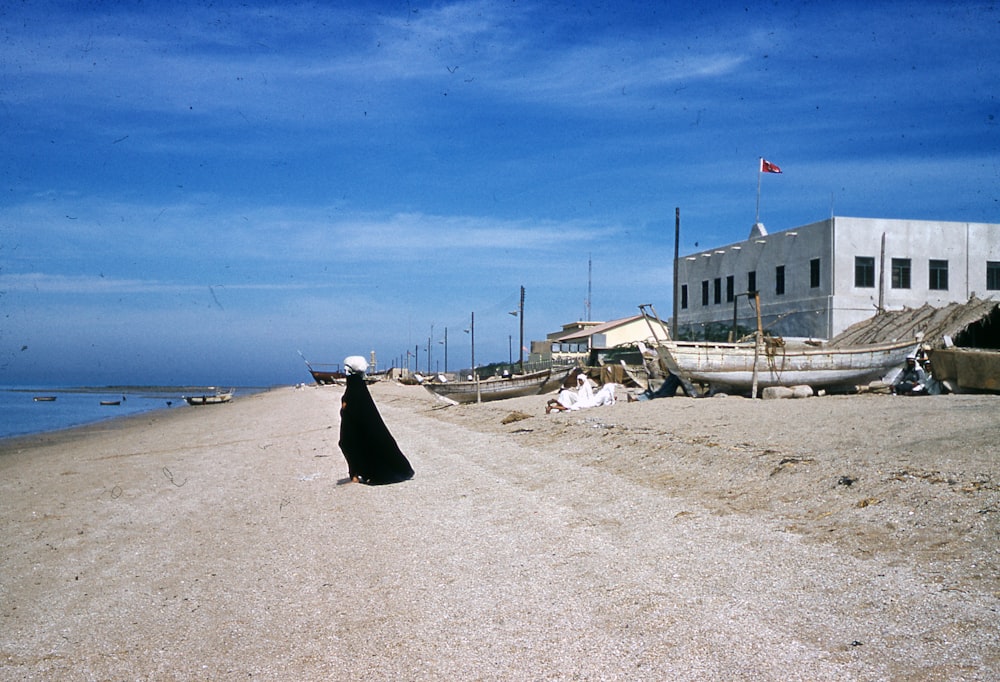 white and black boat on beach during daytime