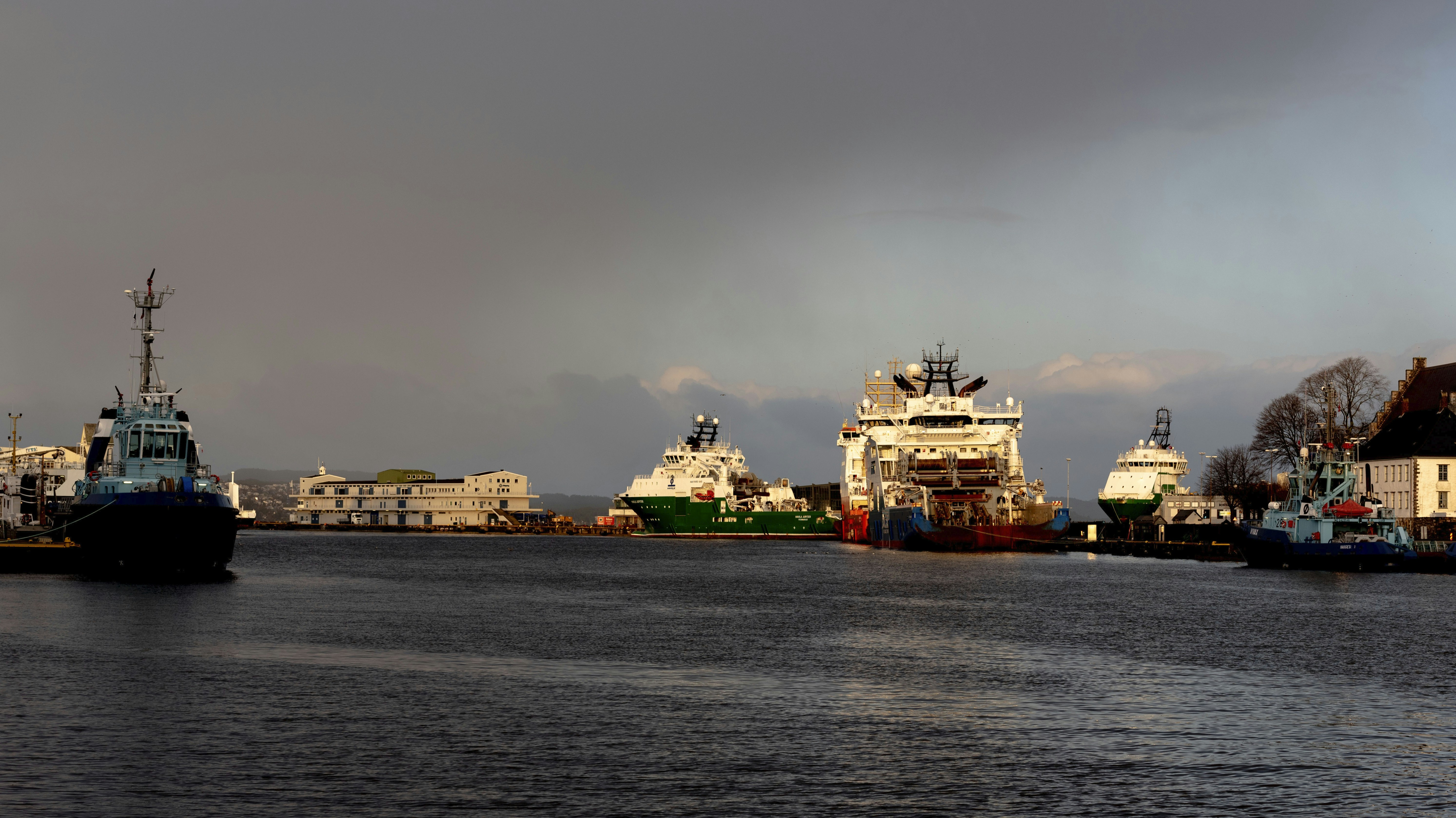 white and brown ship on sea under gray sky