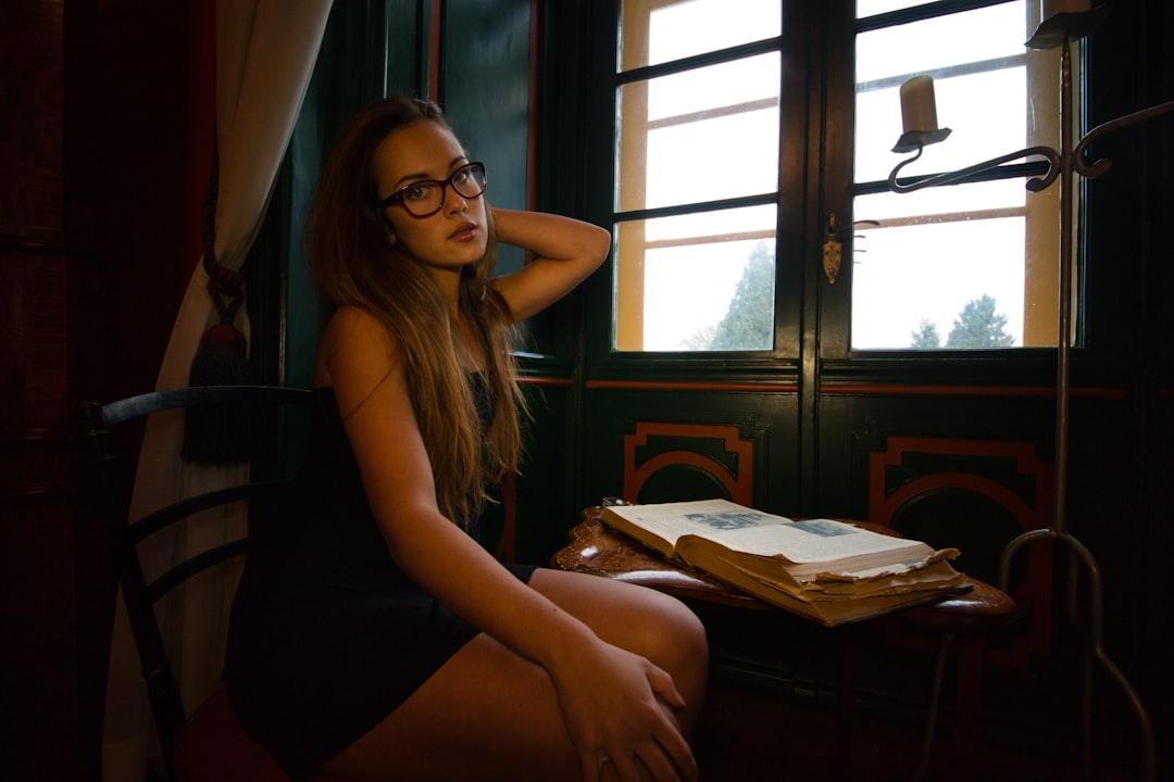 woman in black tank top sitting on chair