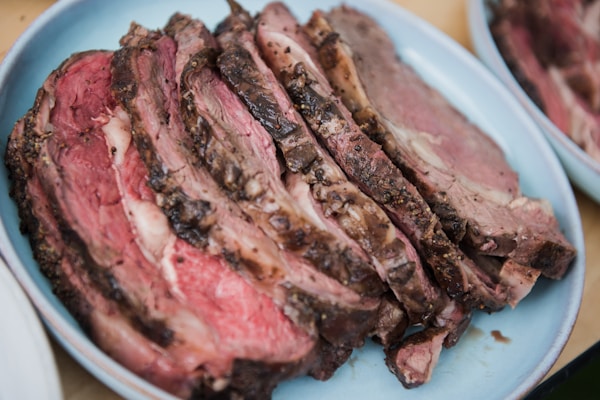 Sliced meat on white ceramic plate