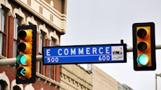 a traffic light with a street sign hanging from it's side