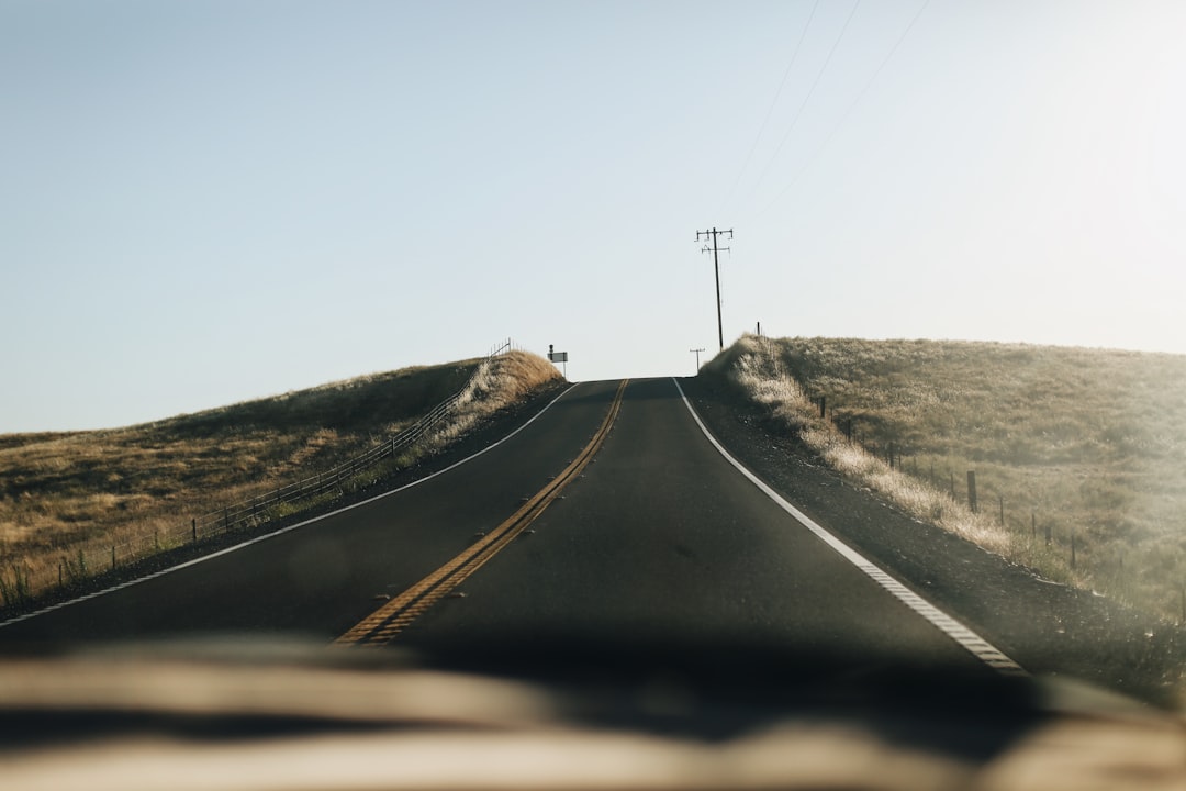 black asphalt road under blue sky during daytime