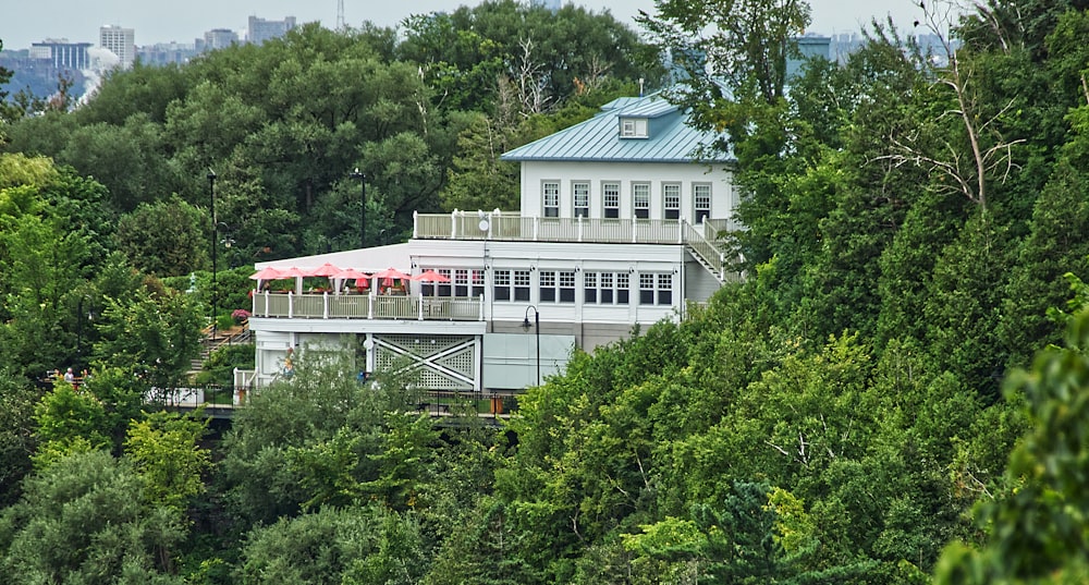 white concrete building surrounded by green trees during daytime