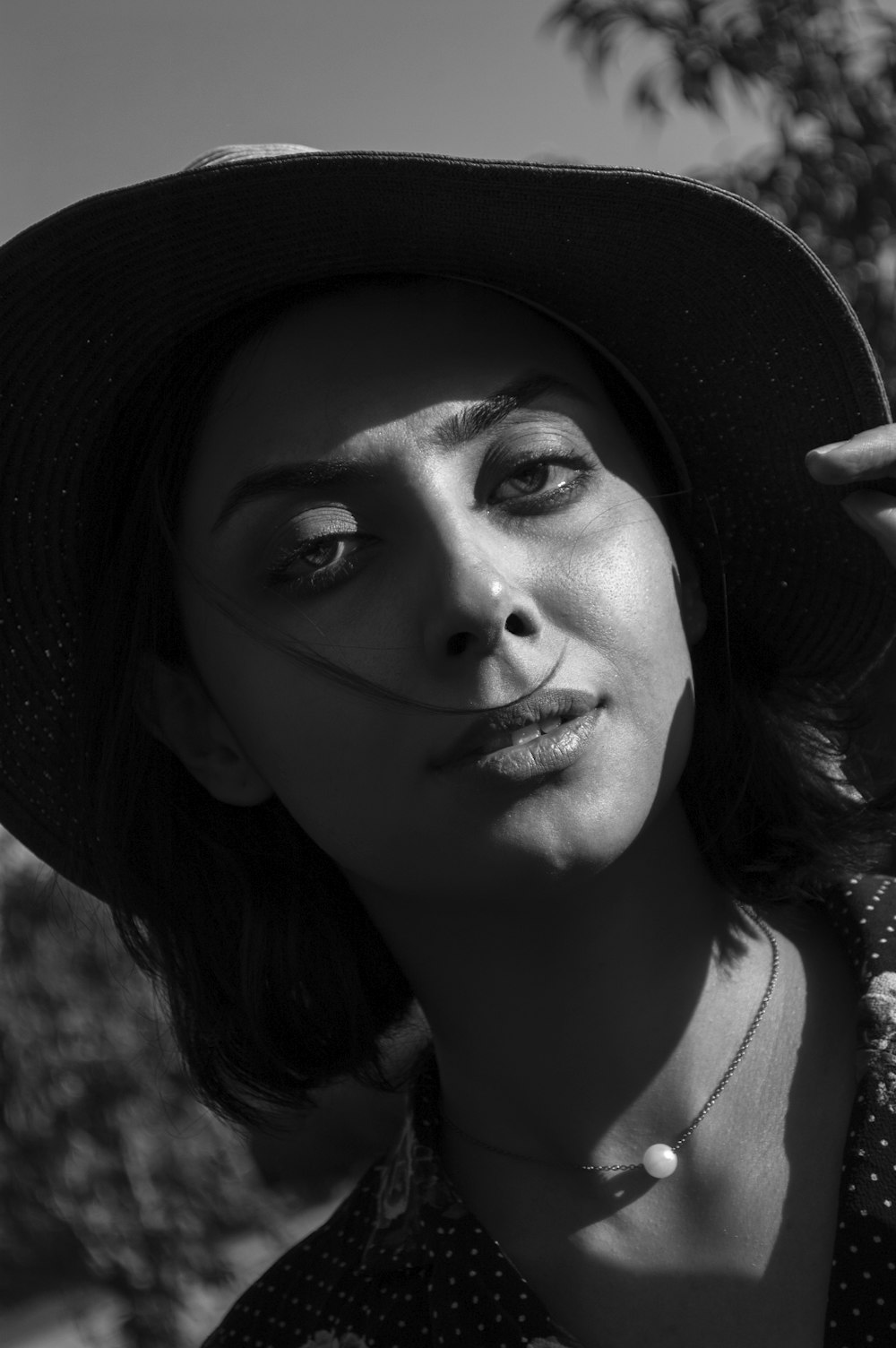 grayscale photo of woman wearing hat