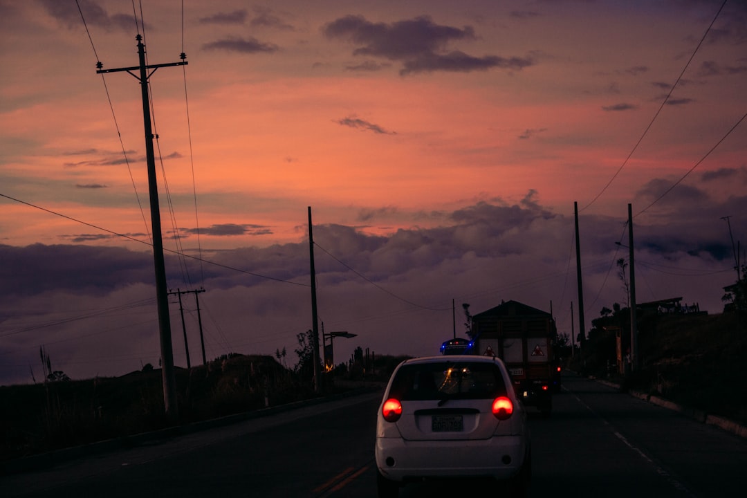 white car on road during sunset