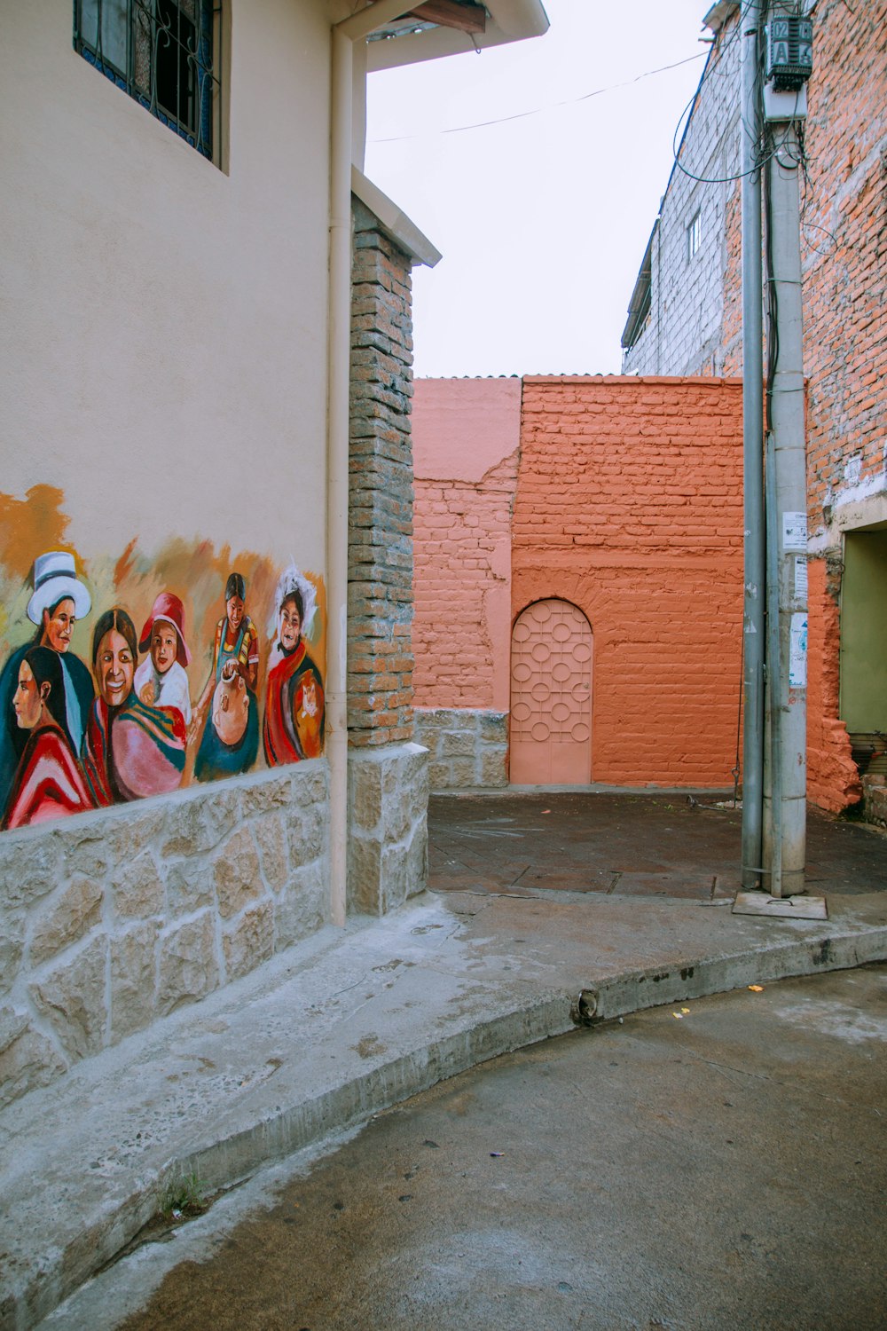 people standing beside brown brick wall during daytime