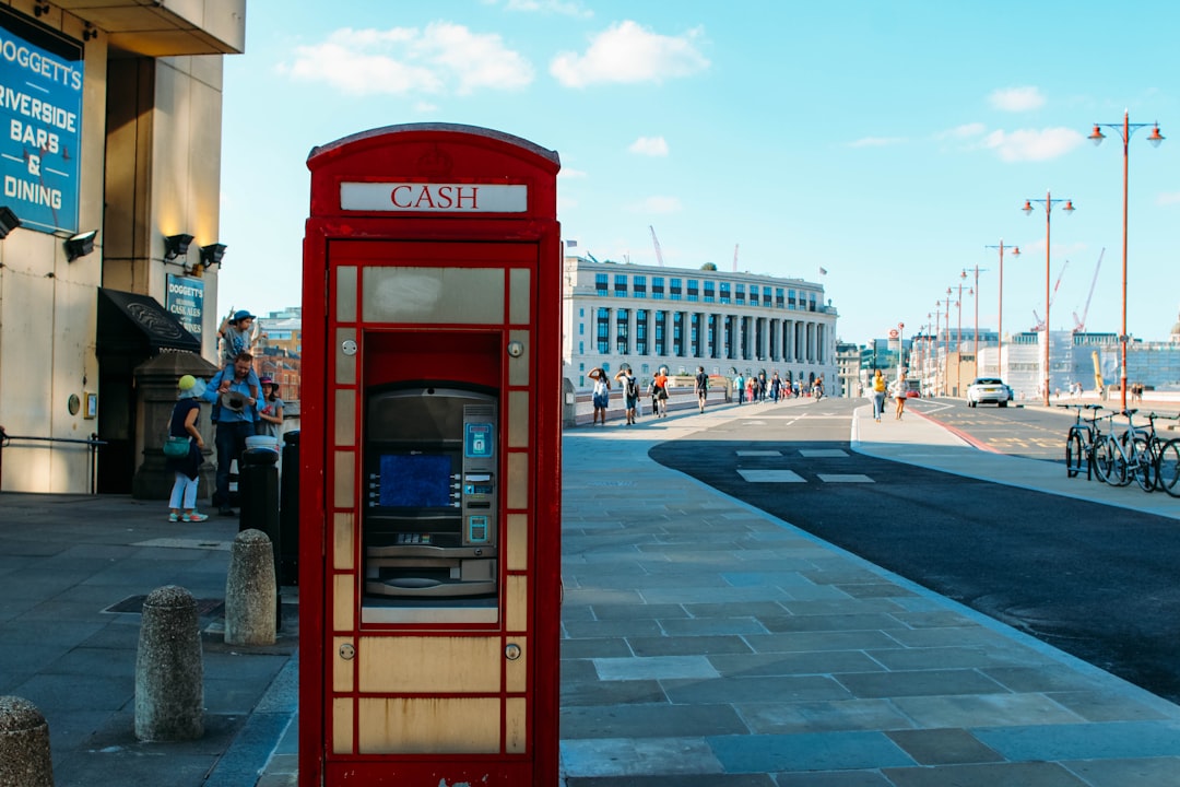 red telephone booth near building during daytime